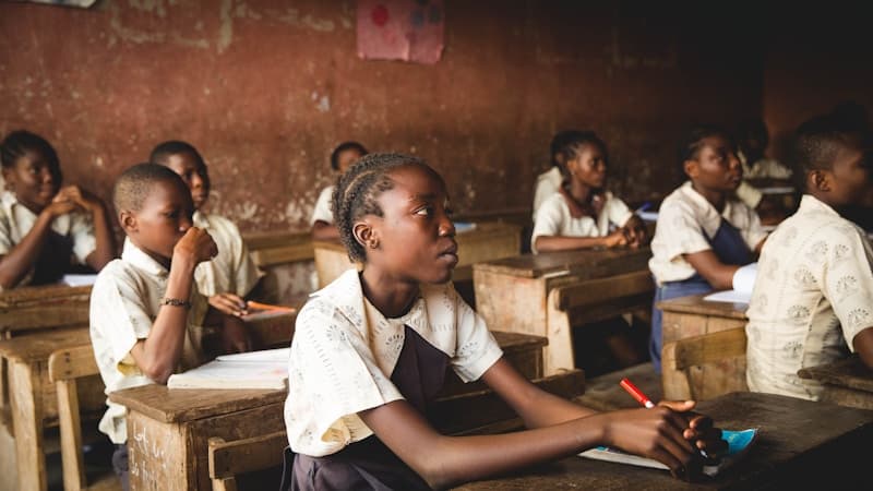 Black African children learning together in a classroom